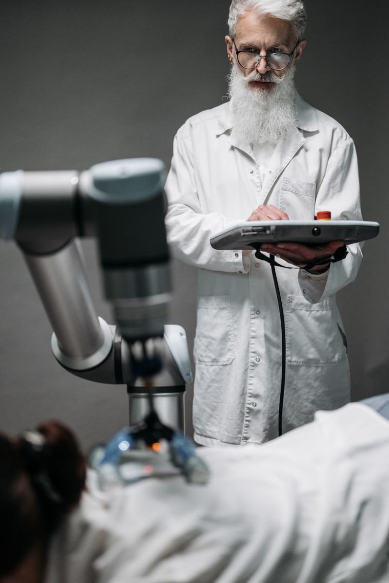 Autonomous Dental Implant Robot: Precision or Peril? Scientist in a white coat operating a robotic arm in a modern laboratory environment.