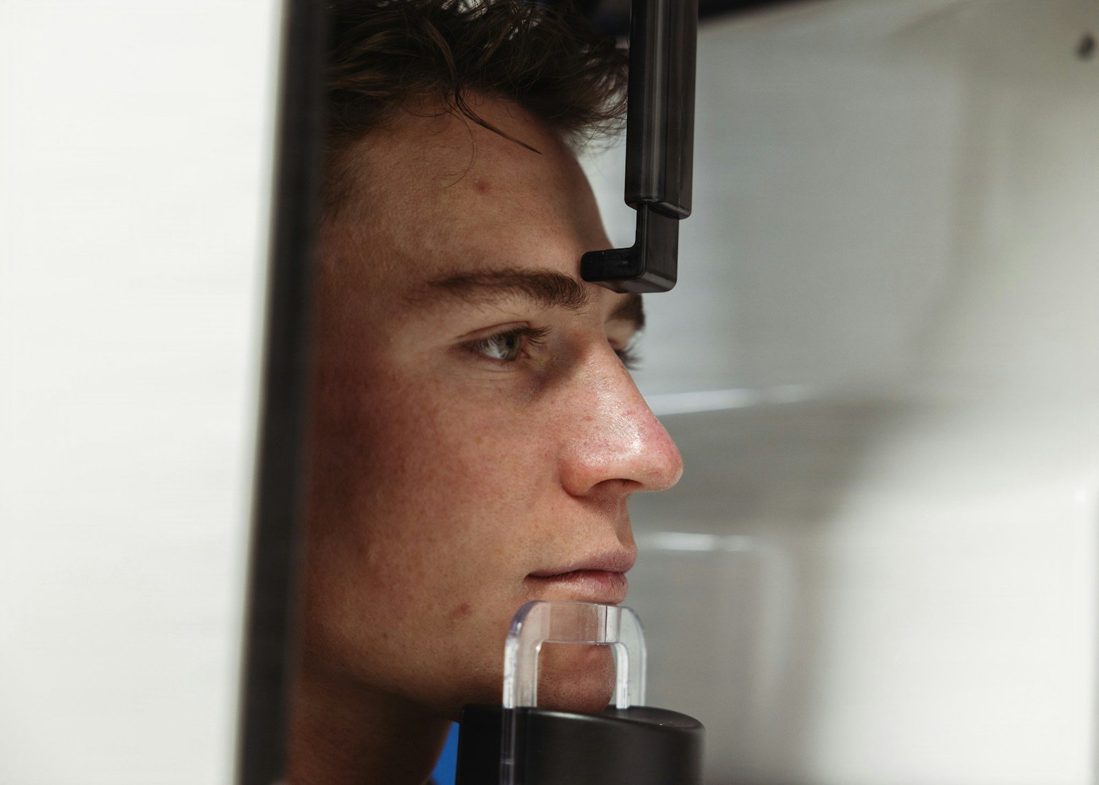 Can AI Cephalometric Landmark Detection Match a Specialist? Young man's face in medical imaging equipment