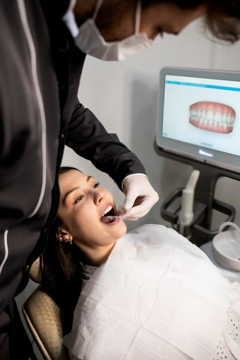 Black Triangles After Clear Aligners: Can AI Predict Them? dentist examining patient with dental scanner